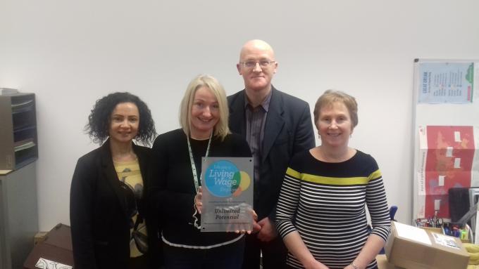 Unlimited Potential Staff posig with their Living Wage Plaque 2018